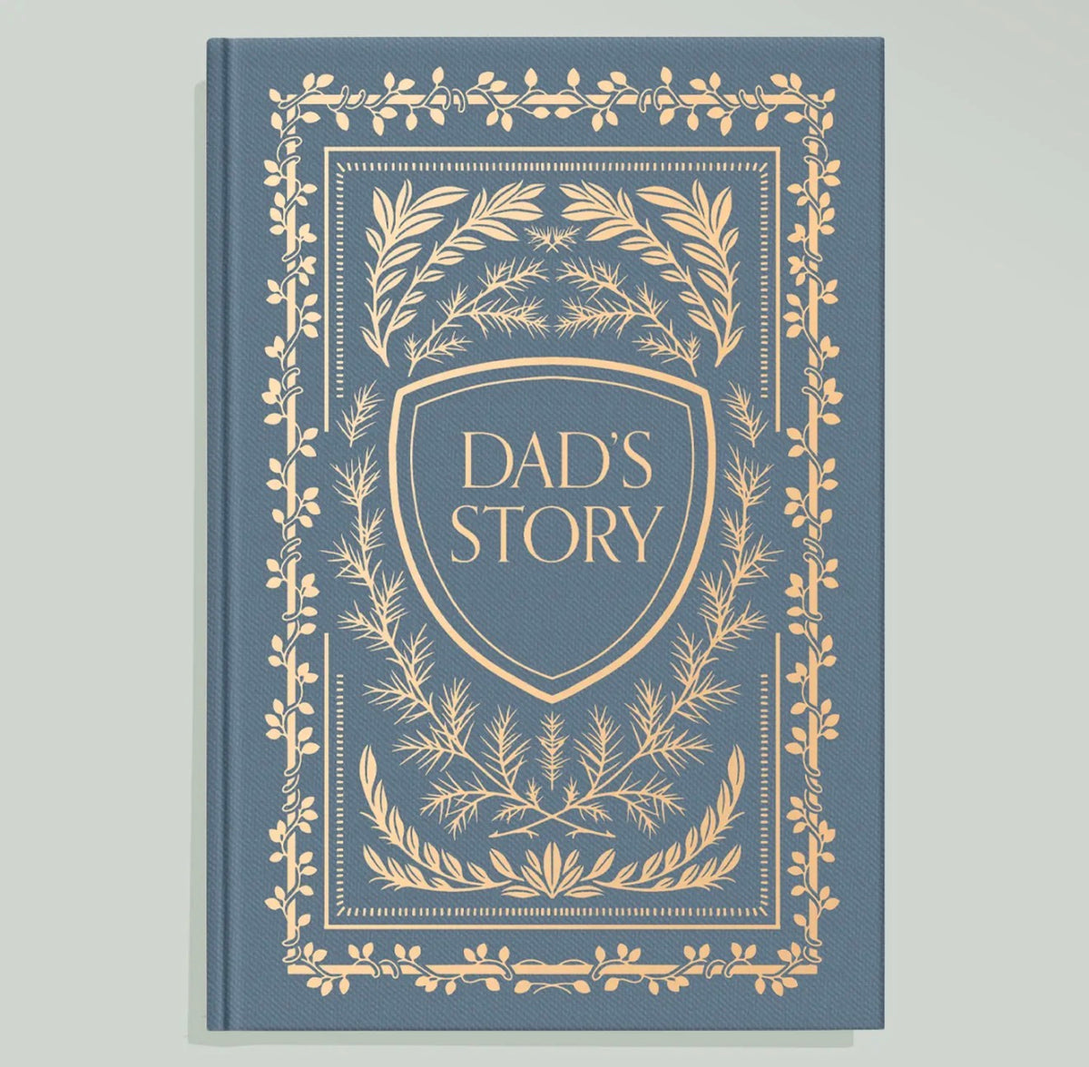 Blue Dad’s Story journal featuring an ornate gold botanical border and shield design with gold lettering on the cover.