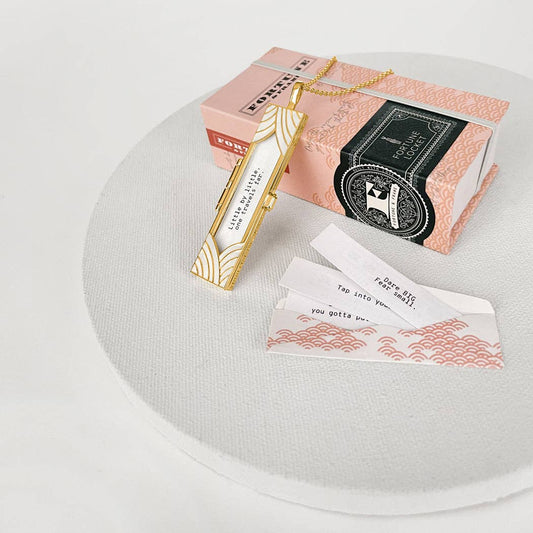 Decorative bookmarks and packaging on a white surface