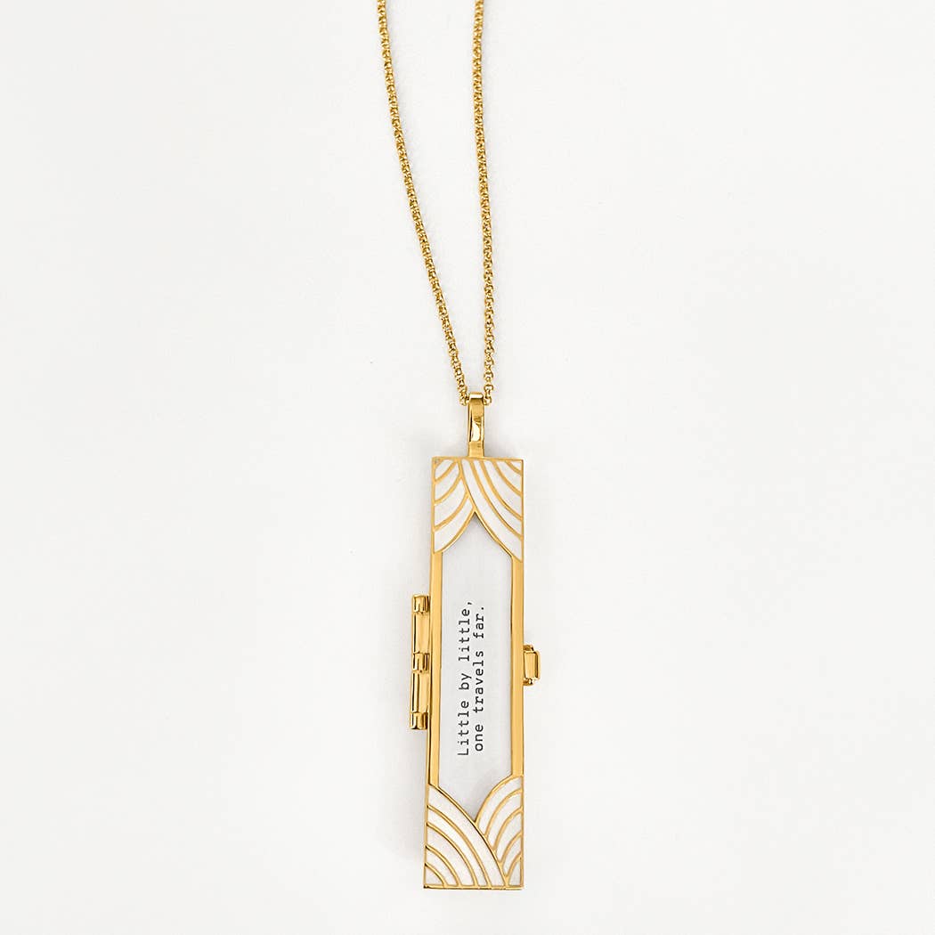 Gold necklace with a rectangular pendant on a white background