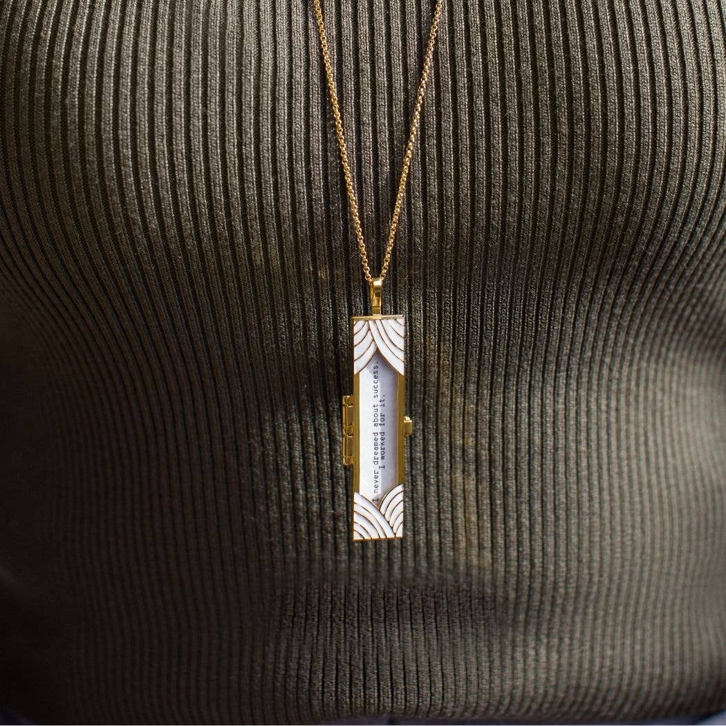 Necklace with a rectangular pendant on a textured surface